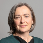 Headshot of Liz Saville Roberts MP, World Horse Welfare trustee wearing a green to against a grey background.