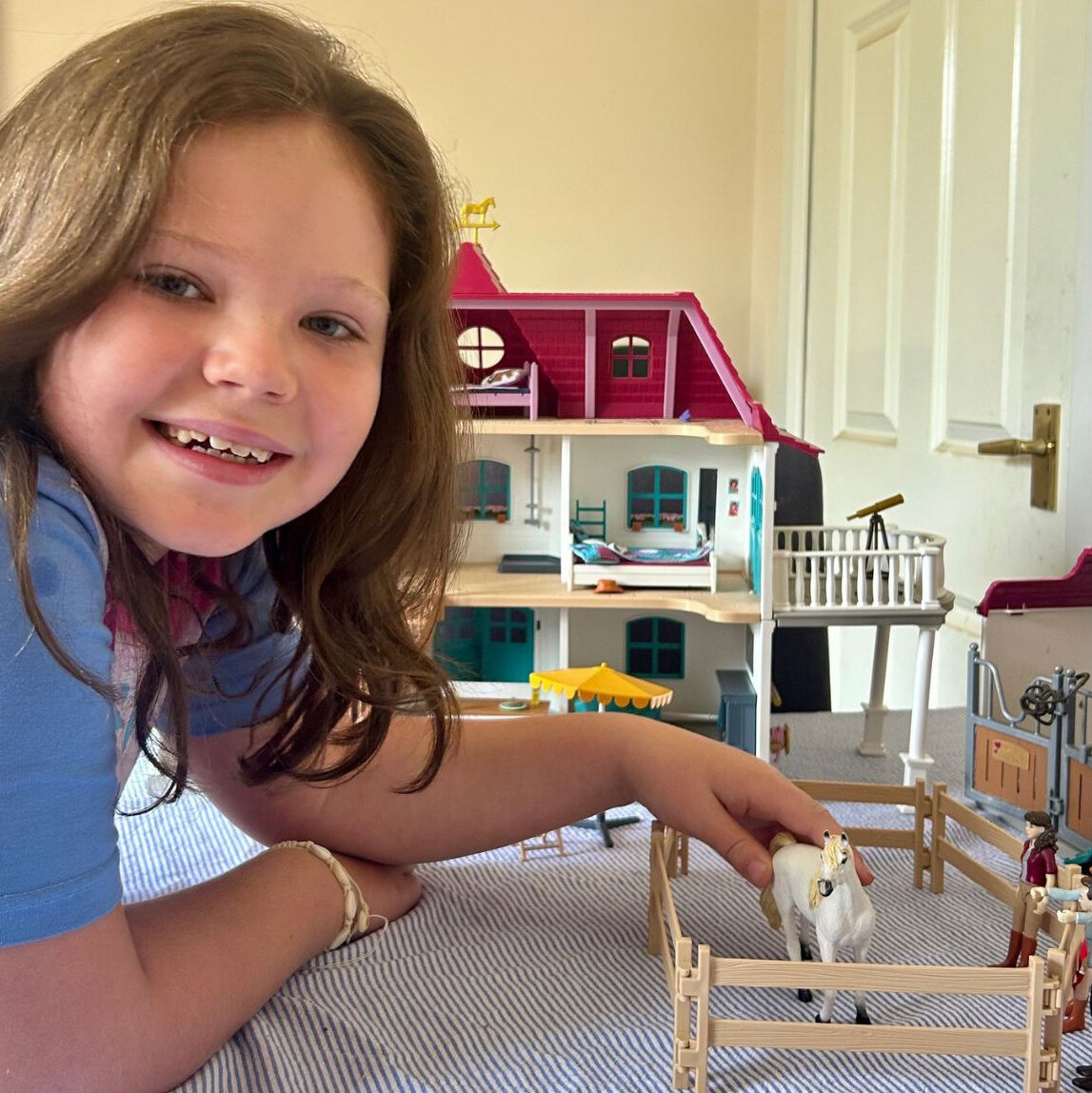 Montage of two girls - the girl on the left playing with a model stable yard and the girl on the right standing next to a grey pony.